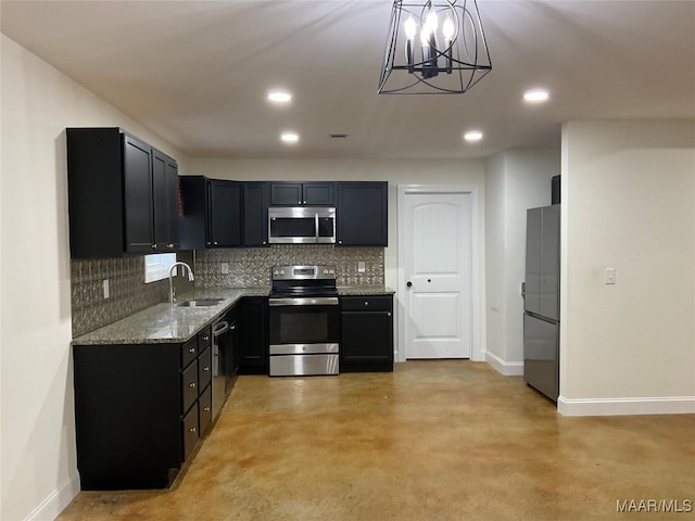 215 Indian Ln, Tallassee, AL 36078 - kitchen with appliances with stainless steel finishes, a sink, baseboards, light stone countertops, and tasteful backsplash