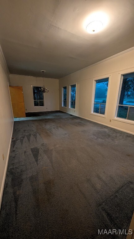 8130 Sorrel Ln, Montgomery, AL 36117 - carpeted spare room with a chandelier, baseboards, and crown molding