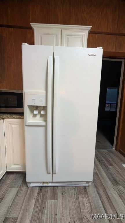 8130 Sorrel Ln, Montgomery, AL 36117 - kitchen with white refrigerator with ice dispenser, stainless steel microwave, wood finished floors, and dark countertops