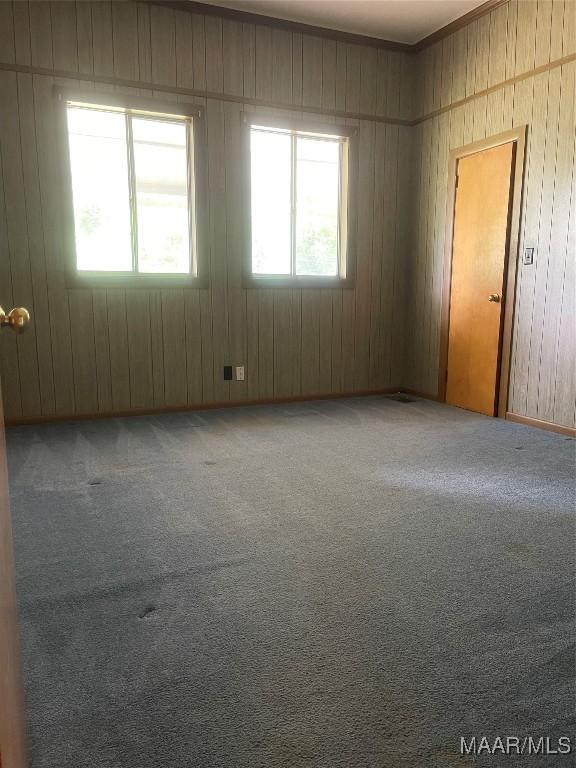 8130 Sorrel Ln, Montgomery, AL 36117 - carpeted empty room featuring wooden walls