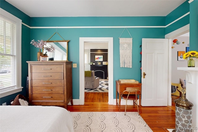 1207 Woodward Ave, Montgomery, AL 36106 - bedroom with wood finished floors and a fireplace