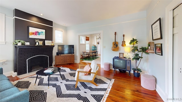 1207 Woodward Ave, Montgomery, AL 36106 - living room featuring wood finished floors, a fireplace, baseboards, and recessed lighting