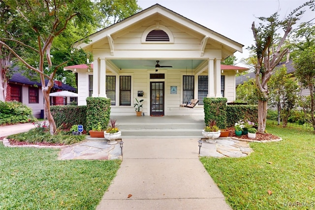 1207 Woodward Ave, Montgomery, AL 36106 - view of front of home with a ceiling fan, covered porch, a front lawn, and concrete driveway