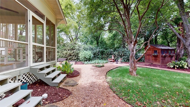 1207 Woodward Ave, Montgomery, AL 36106 - view of yard with a sunroom, an outbuilding, and view of wooded area