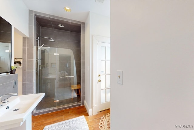 1207 Woodward Ave, Montgomery, AL 36106 - full bath featuring a stall shower, recessed lighting, wood finished floors, and a sink