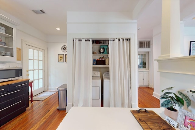 1207 Woodward Ave, Montgomery, AL 36106 - bedroom featuring wood finished floors, independent washer and dryer, recessed lighting, and baseboards