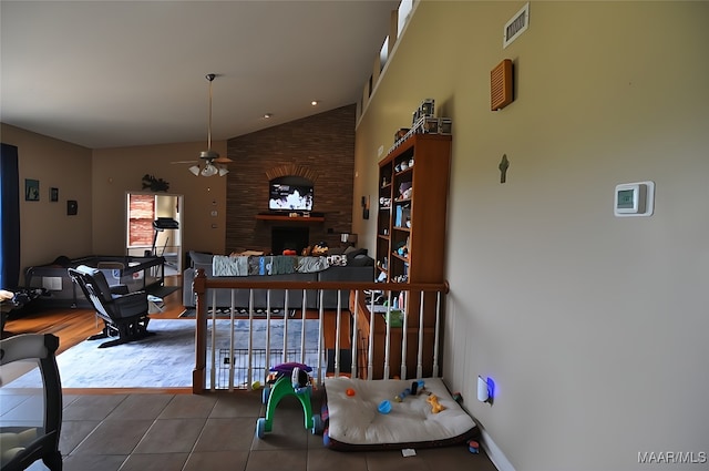 1496 County Road 81st Rd, Prattville, AL 36067 - tiled living room with vaulted ceiling, a ceiling fan, and a fireplace