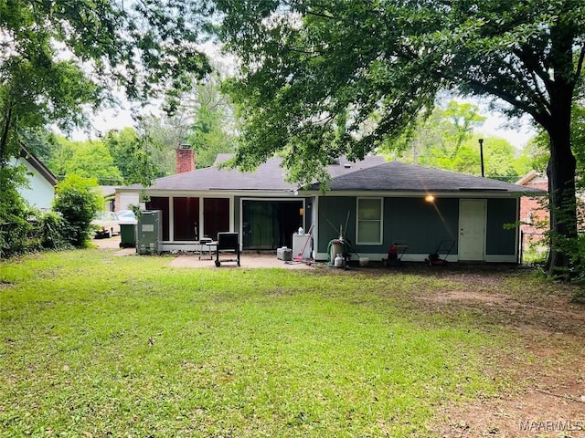 452 Planters Rd, Montgomery, AL 36109 - back of property with a yard, a chimney, and a sunroom