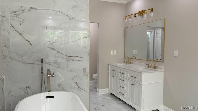 bathroom featuring marble finish floors, a soaking tub, double vanity, toilet, and baseboards