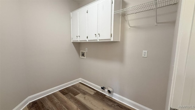 clothes washing area with hookup for a washing machine, cabinet space, gas dryer hookup, dark wood finished floors, and baseboards