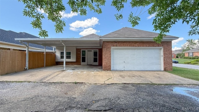 ranch-style home with fence, a garage, brick siding, roof with shingles, and driveway