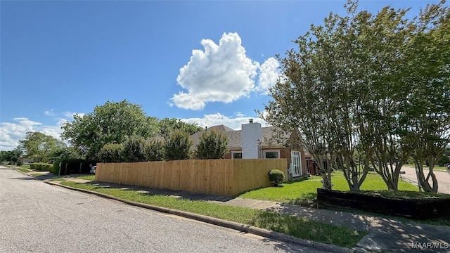 view of home's exterior with fence