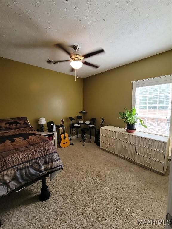 109 Coleman Dr, Prattville, AL 36067 - bedroom with light colored carpet, a textured ceiling, and ceiling fan