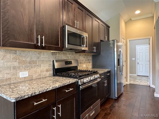 9145 Autumn Brooke Way, Montgomery, AL 36117 - kitchen with stainless steel appliances, dark brown cabinetry, light stone countertops, decorative backsplash, and crown molding