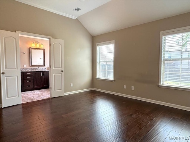 9145 Autumn Brooke Way, Montgomery, AL 36117 - unfurnished bedroom featuring multiple windows, wood finished floors, vaulted ceiling, and ensuite bathroom