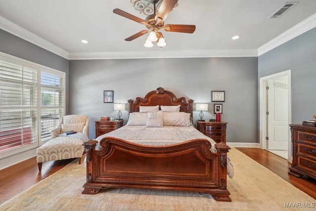 bedroom featuring crown molding, wood finished floors, baseboards, recessed lighting, and ceiling fan