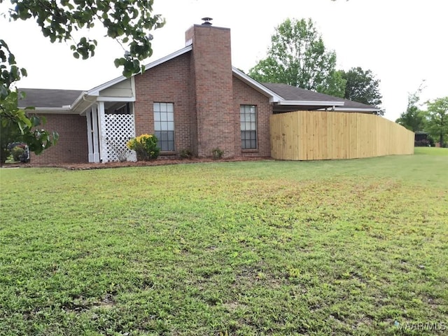 view of property exterior featuring brick siding and a chimney