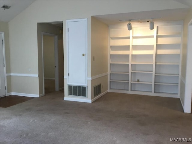 unfurnished room with carpet floors, rail lighting, and baseboards