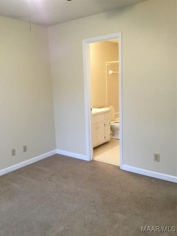 carpeted spare room with baseboards
