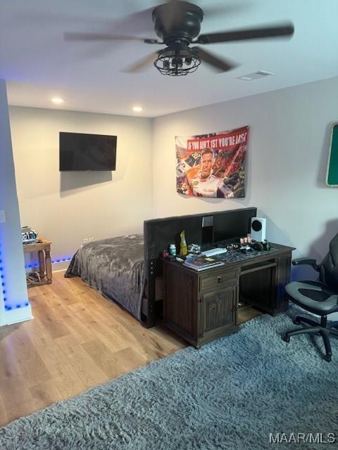 bedroom featuring an office area, wood finished floors, a ceiling fan, and recessed lighting
