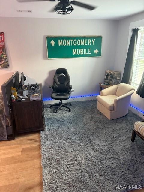 office area with wood finished floors and a ceiling fan