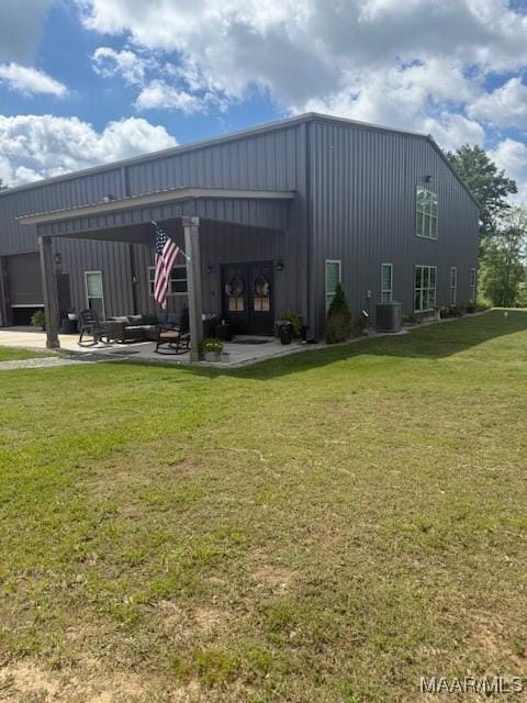 view of outbuilding with french doors and an outdoor living space