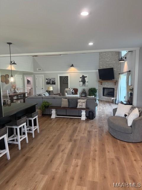 living area featuring wood finished floors and a large fireplace
