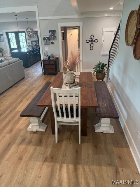 dining room featuring wood finished floors and baseboards