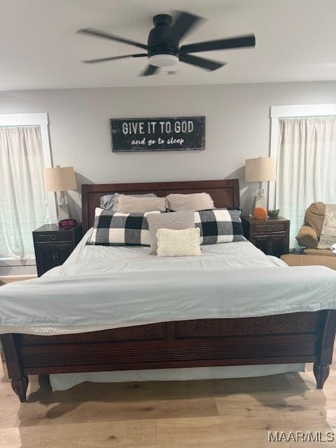 bedroom with wood finished floors and ceiling fan