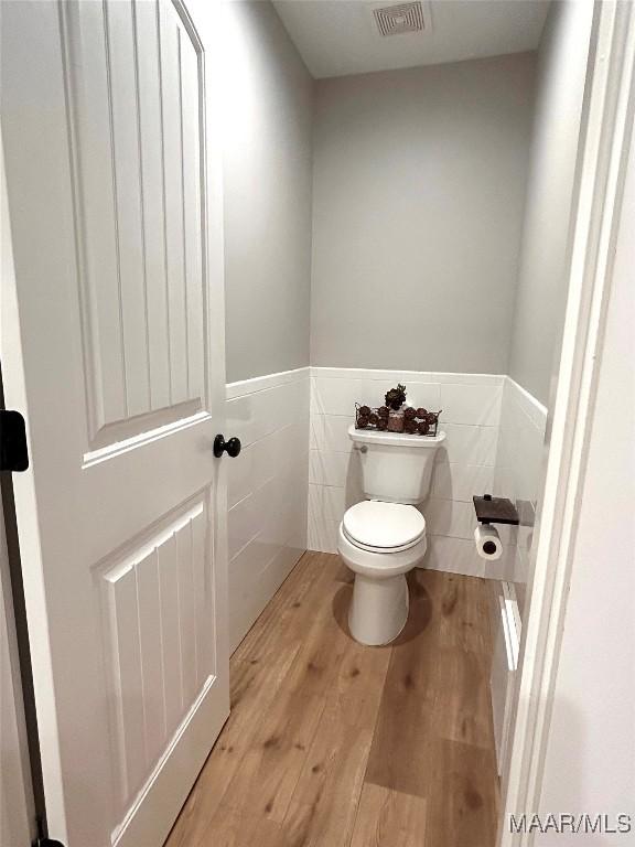2533 Weldon Rd, Tallassee, AL 36078 - bathroom with tile walls, wood finished floors, and a wainscoted wall
