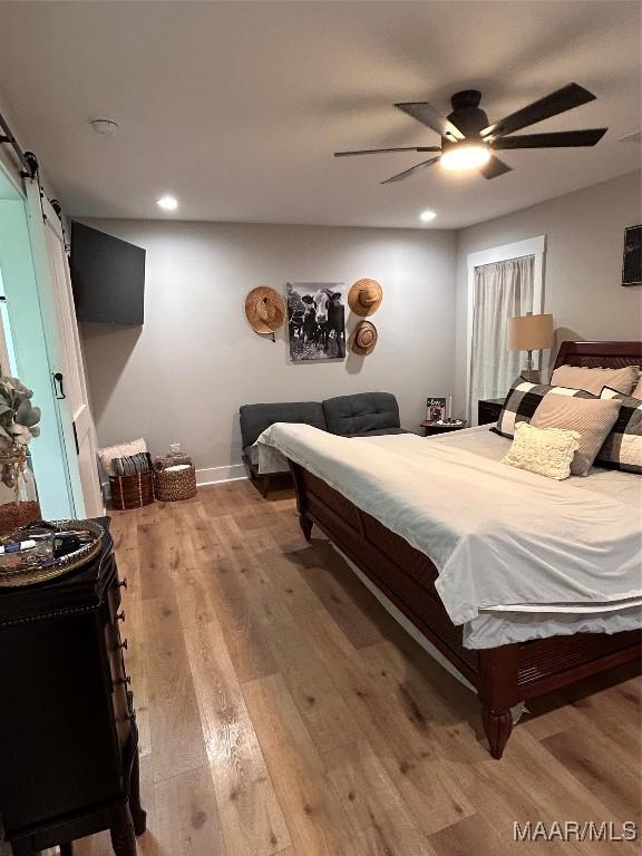2533 Weldon Rd, Tallassee, AL 36078 - bedroom featuring light wood-style flooring, a barn door, recessed lighting, and ceiling fan