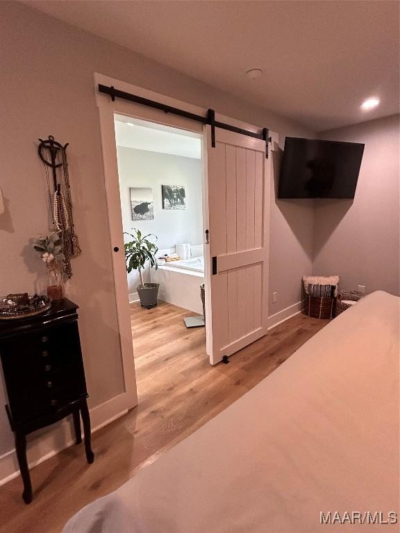 2533 Weldon Rd, Tallassee, AL 36078 - bedroom with wood finished floors, a barn door, and recessed lighting