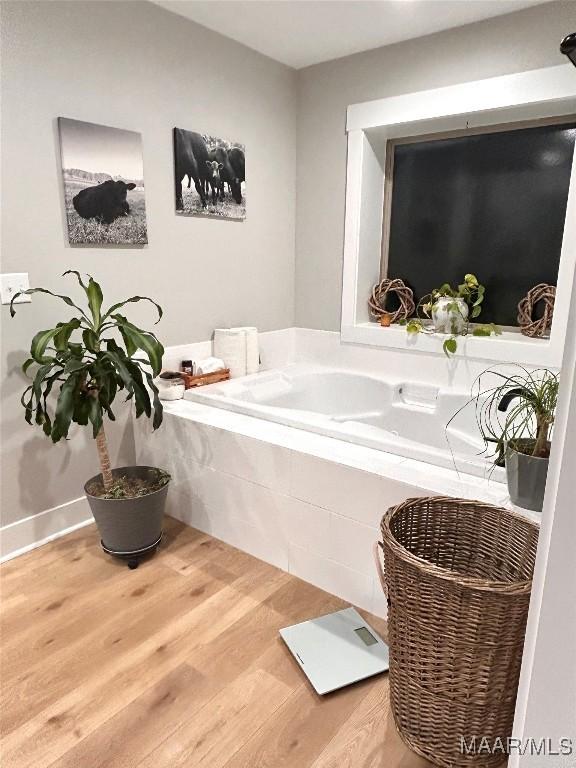 2533 Weldon Rd, Tallassee, AL 36078 - full bathroom featuring wood finished floors and a bath