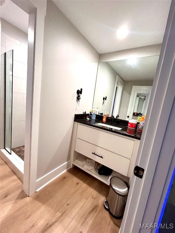 2533 Weldon Rd, Tallassee, AL 36078 - bathroom with wood finished floors, vanity, and a tile shower