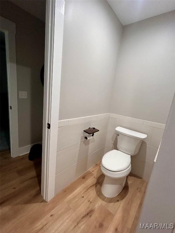 2533 Weldon Rd, Tallassee, AL 36078 - bathroom with tile walls, wood finished floors, and wainscoting