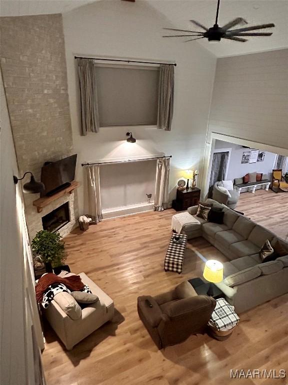 2533 Weldon Rd, Tallassee, AL 36078 - living room with lofted ceiling, wood finished floors, ceiling fan, and a fireplace
