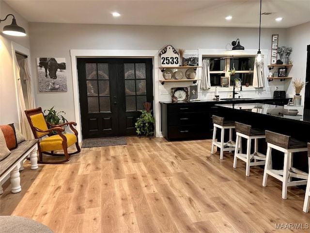 2533 Weldon Rd, Tallassee, AL 36078 - bar with light wood-style flooring, recessed lighting, and hanging light fixtures