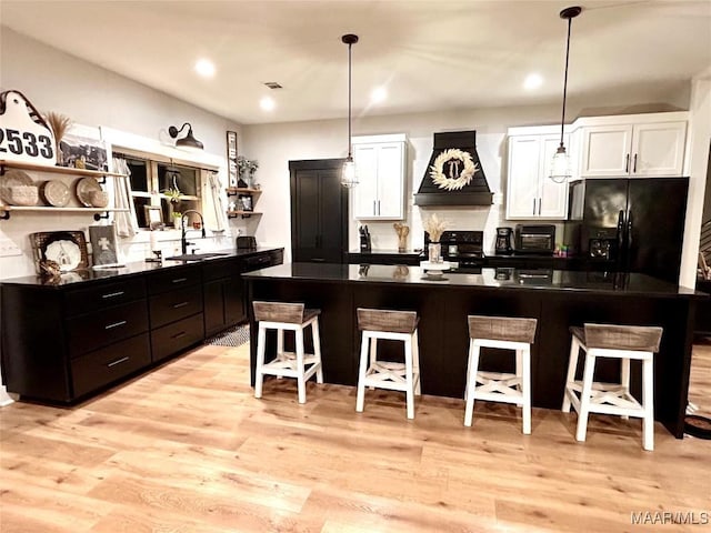 2533 Weldon Rd, Tallassee, AL 36078 - kitchen featuring open shelves, black appliances, custom range hood, dark countertops, and white cabinetry