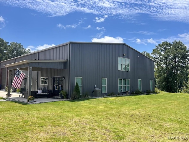 2533 Weldon Rd, Tallassee, AL 36078 - rear view of house with a patio, an outdoor living space, a lawn, and board and batten siding