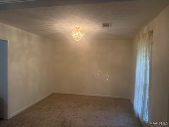 176 Lawrence Cv, Valley Grande, AL 36703 - unfurnished room with a chandelier, carpet flooring, baseboards, and healthy amount of natural light