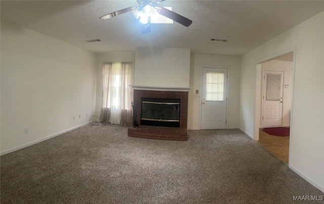 176 Lawrence Cv, Valley Grande, AL 36703 - unfurnished living room with a ceiling fan, carpet, a fireplace, baseboards, and a textured ceiling