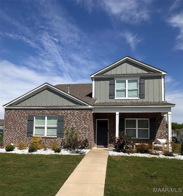 5168 Sedona Dr, Montgomery, AL 36116 - view of front facade with board and batten siding, brick siding, and a front lawn