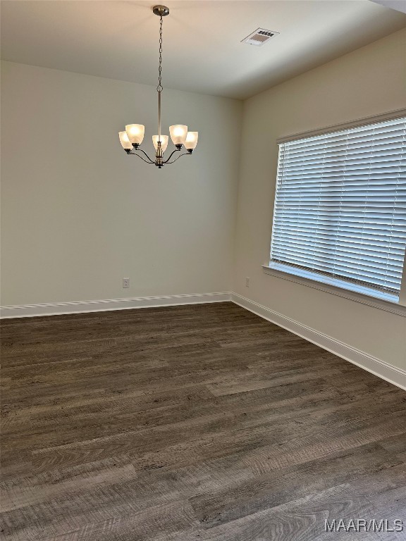 5168 Sedona Dr, Montgomery, AL 36116 - unfurnished room featuring a chandelier, baseboards, and dark wood-style flooring