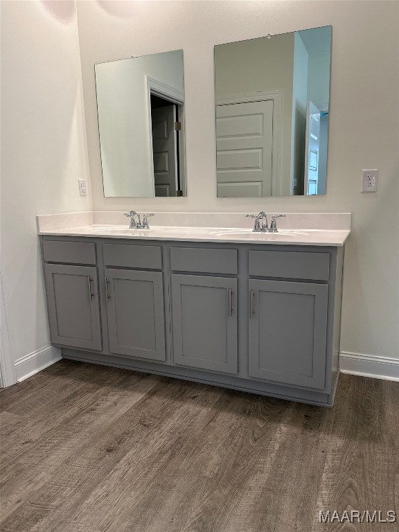 5168 Sedona Dr, Montgomery, AL 36116 - bathroom with double vanity, wood finished floors, and baseboards