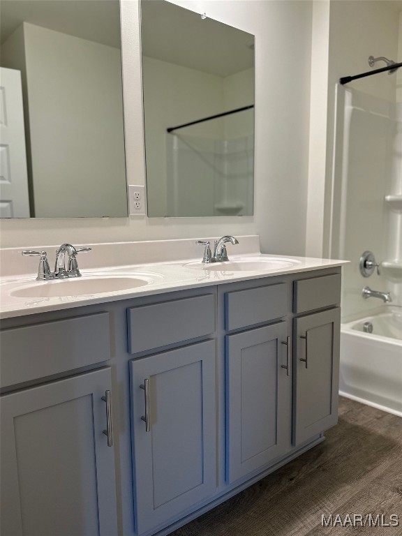 5168 Sedona Dr, Montgomery, AL 36116 - bathroom featuring double vanity, shower / bath combination, and wood finished floors
