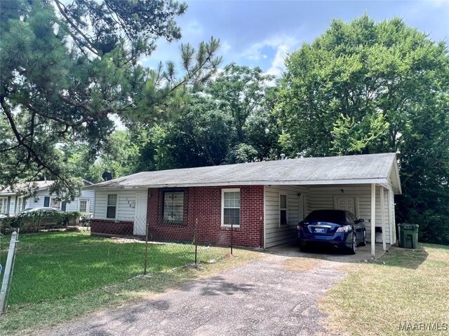 124 W Michigan Ave, Montgomery, AL 36110 - ranch-style home featuring asphalt driveway, a front lawn, an attached carport, and brick siding