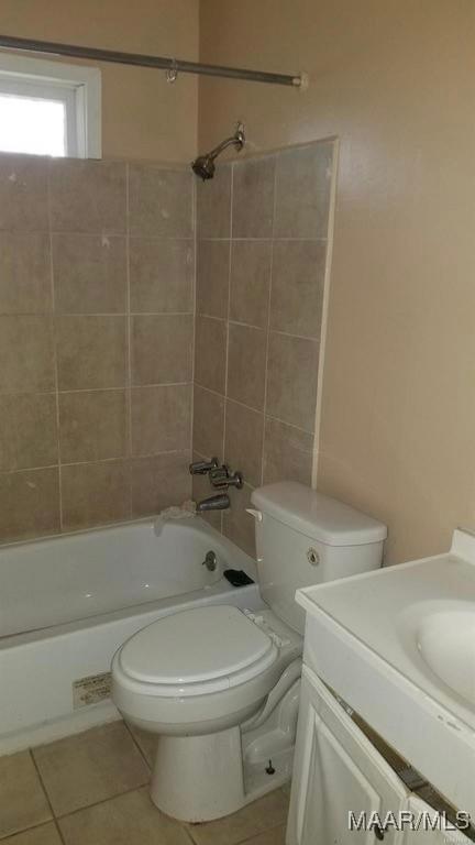 124 W Michigan Ave, Montgomery, AL 36110 - full bathroom featuring tile patterned flooring, toilet, vanity, and tub / shower combination