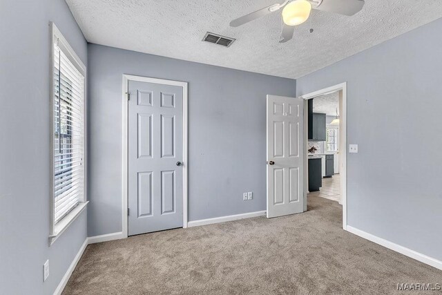 461 W Dr, Prattville, AL 36067 - unfurnished bedroom with carpet flooring, a textured ceiling, baseboards, and a ceiling fan