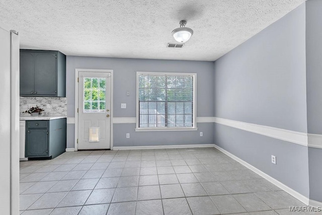 461 W Dr, Prattville, AL 36067 - unfurnished dining area with light tile patterned floors, a textured ceiling, and baseboards