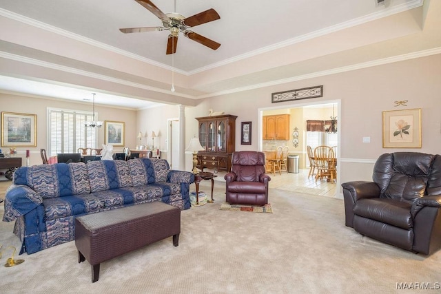 living room with a chandelier, a ceiling fan, light carpet, and crown molding